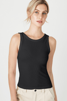 Stylish woman flaunting FORMA's Kelly Reversible Ribbed Tank Top, emphasizing its versatility and snug fit.