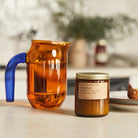 Elegant Black Fig Soy Candle in a glass container, flickering with a warm and soothing glow.