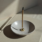 A stylish Brass Arch Incense Holder on a sleek backdrop, exuding modern elegance, designed to hold incense effortlessly.
