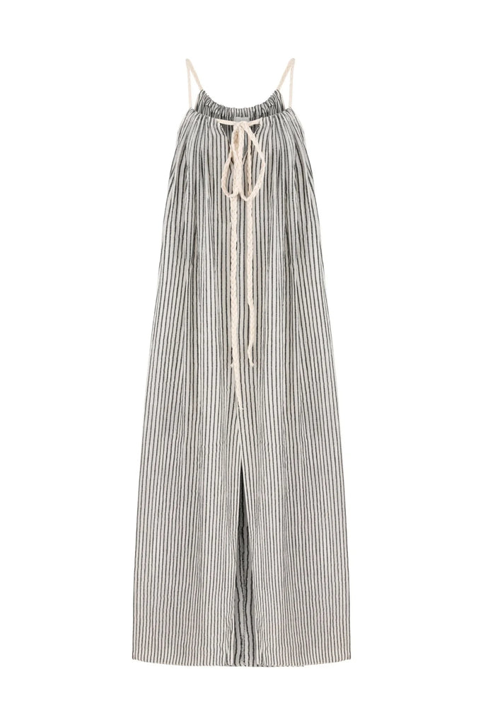 A woman wearing the Breeze Beach Dress, showcasing its relaxed and flowy silhouette, adjustable straps, and vibrant colors, perfect for a beach getaway.