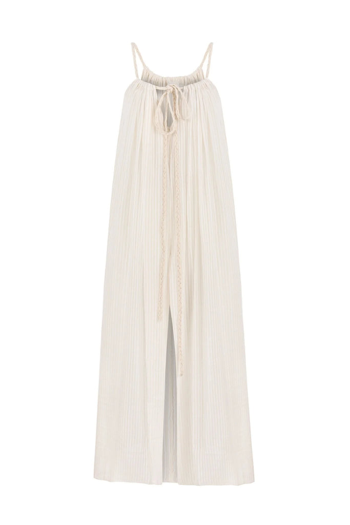 A woman wearing the Breeze Beach Dress, showcasing its relaxed and flowy silhouette, adjustable straps, and vibrant colors, perfect for a beach getaway.