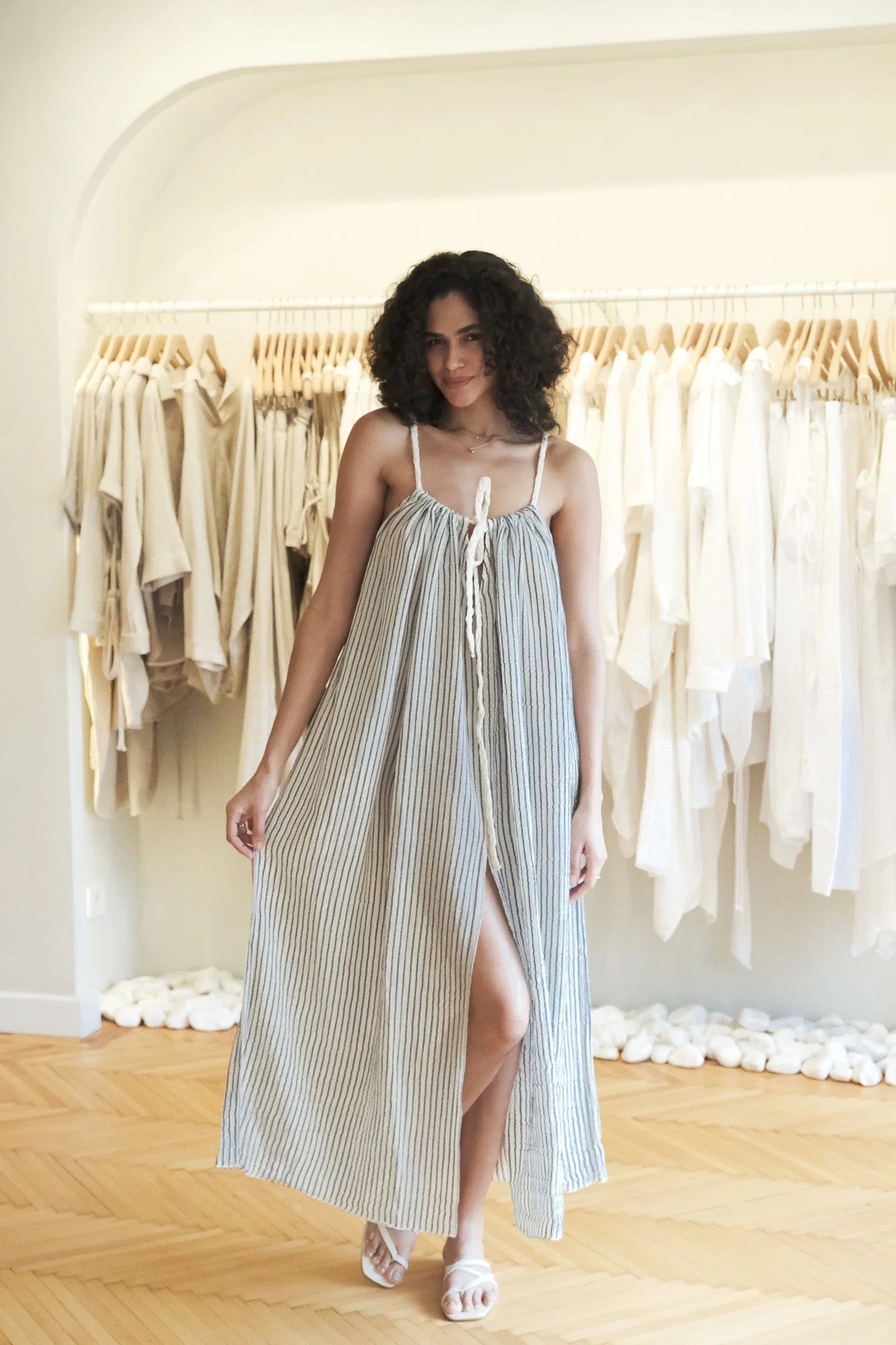 A woman wearing the Breeze Beach Dress, showcasing its relaxed and flowy silhouette, adjustable straps, and vibrant colors, perfect for a beach getaway.