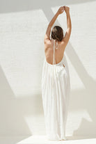 A woman wearing the Breeze Beach Dress, showcasing its relaxed and flowy silhouette, adjustable straps, and vibrant colors, perfect for a beach getaway.