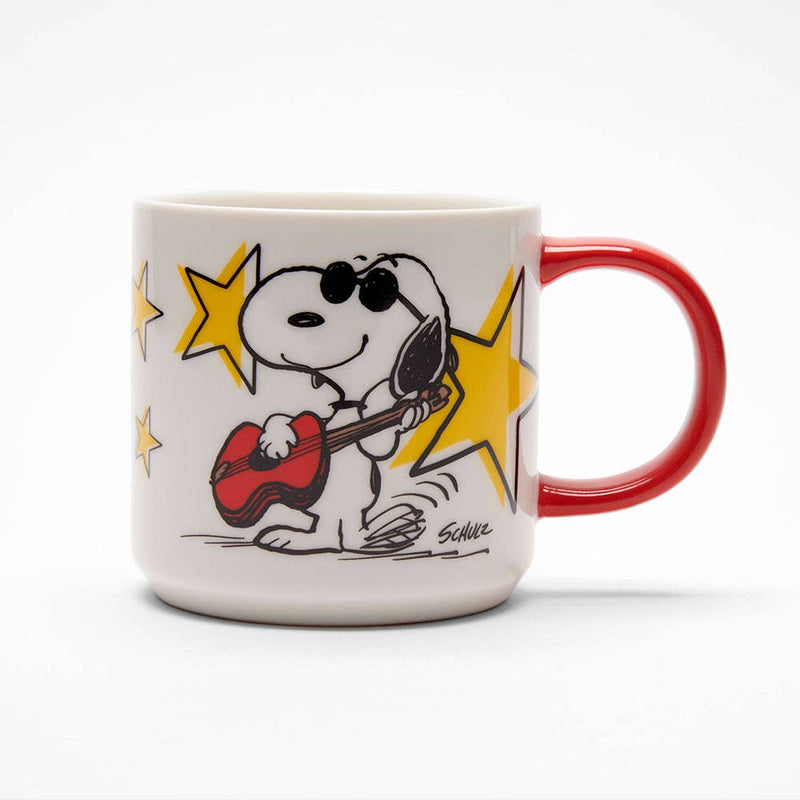 White ceramic mug with a red handle featuring a cool character playing a guitar, surrounded by yellow stars, with "Rock Star" printed on the back.