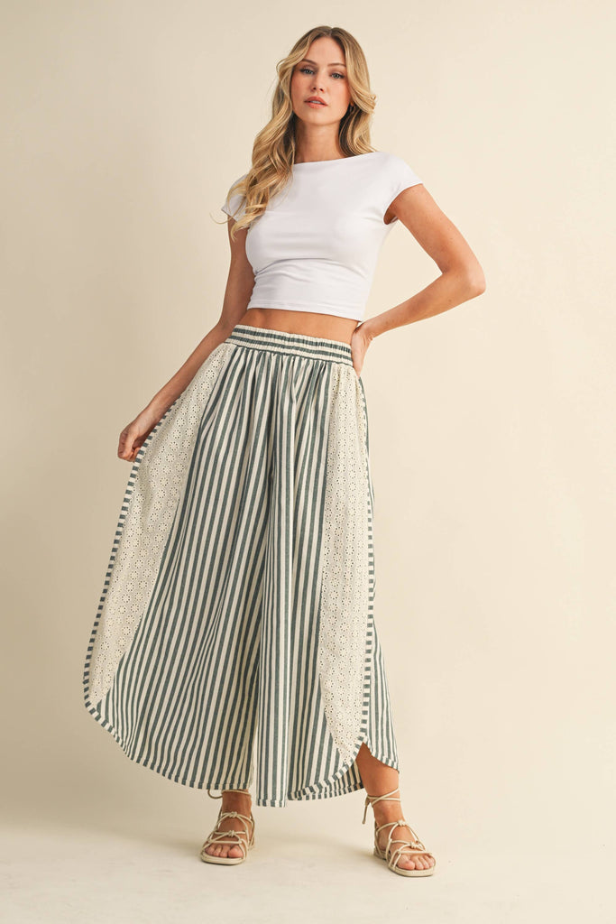 Striped wide-leg pants with floral eyelet side panels and elastic waistband, styled with a white crop top