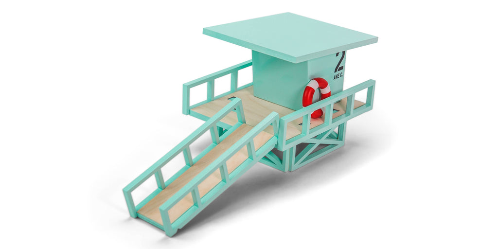Toy lifeguard stand with a red life preserver on a white background