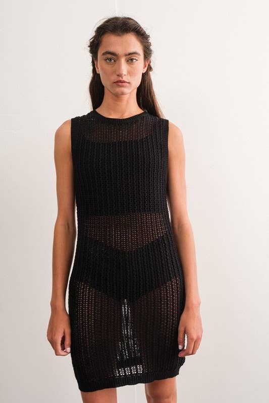Woman wearing a sleeveless black crochet mini dress.