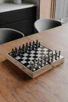 Modern Buddy chess set with mirrored board and gunmetal and silver figure pieces
