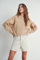 Sandridge Cable Knit Sweater with intricate cable detailing, relaxed fit, and warm beige hue, perfect for layering in any season.
