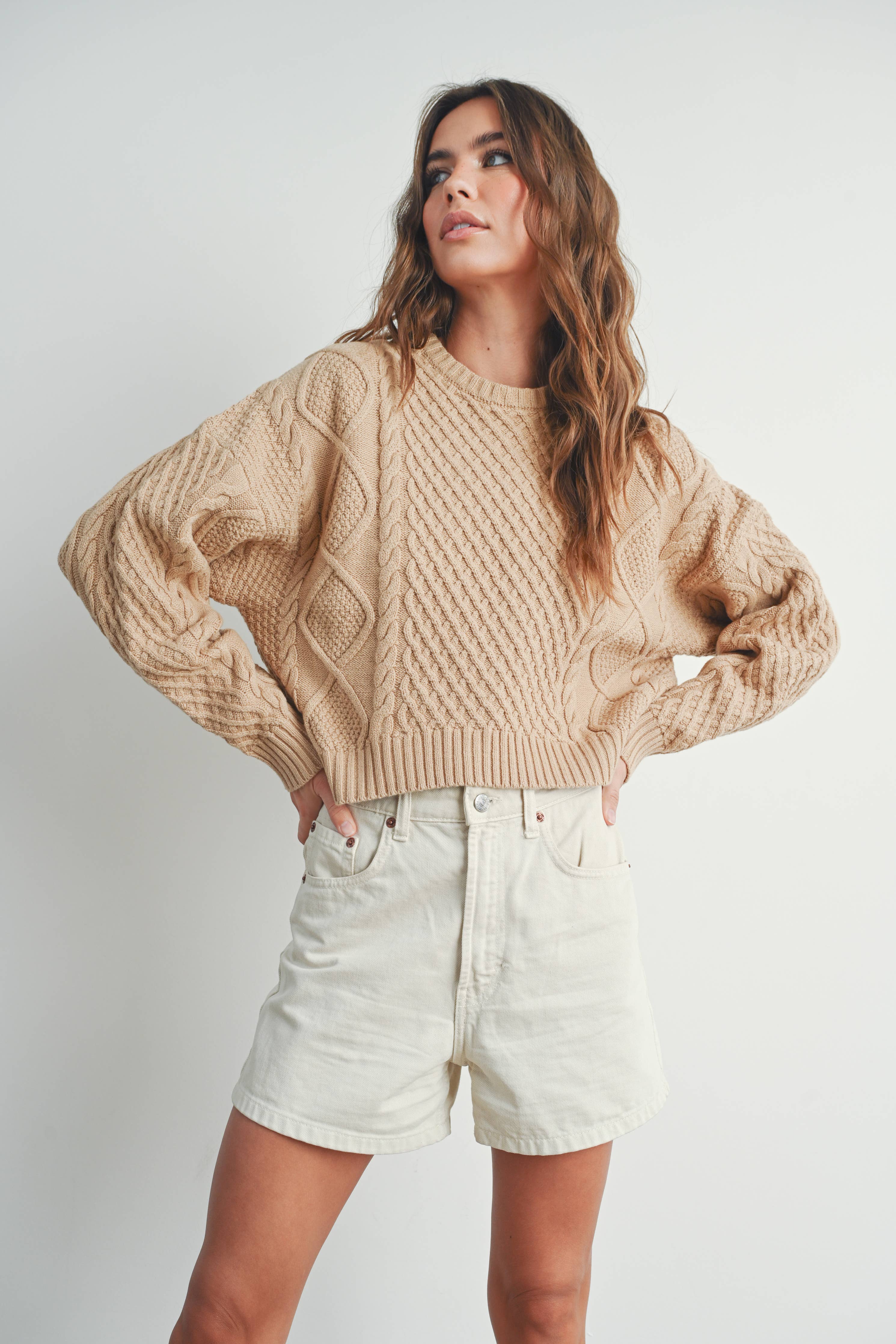 Sandridge Cable Knit Sweater with intricate cable detailing, relaxed fit, and warm beige hue, perfect for layering in any season.