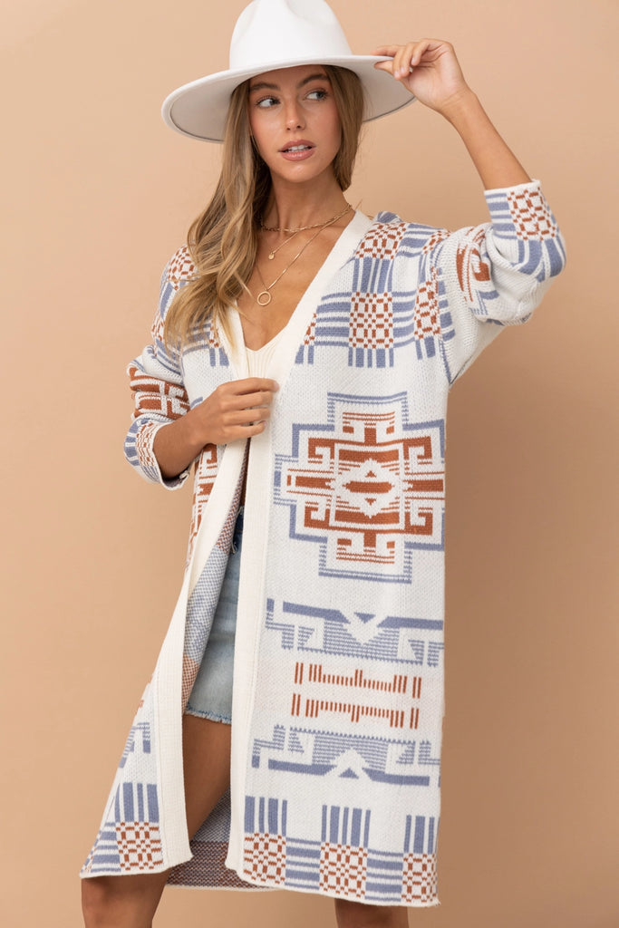 A stylish Erica Aztec Pattern Cardigan draped on a hanger.