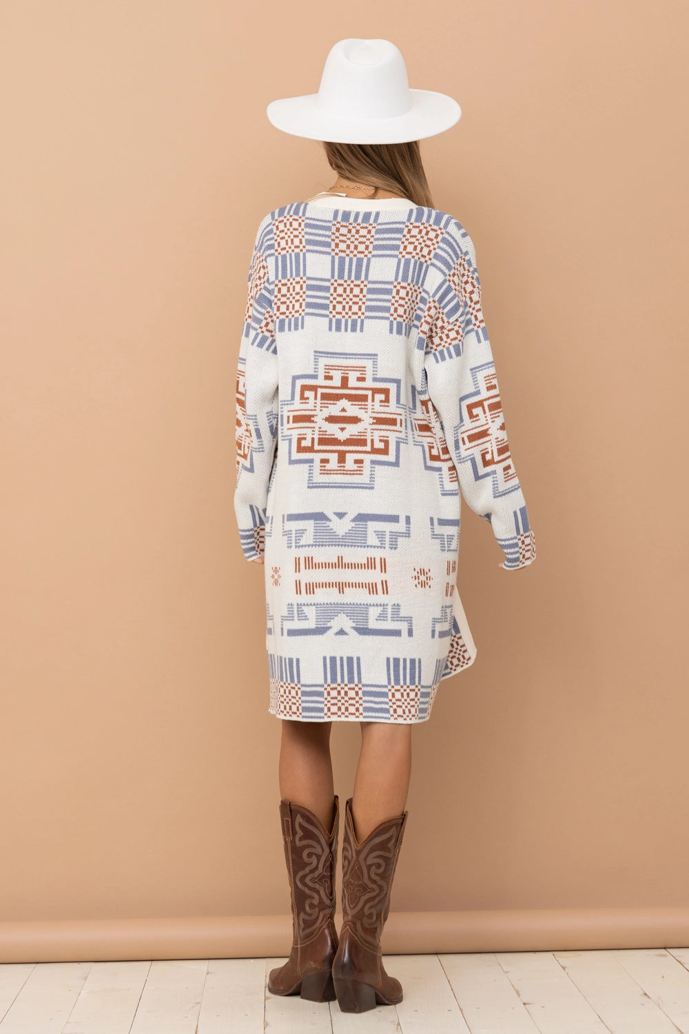 A stylish Erica Aztec Pattern Cardigan draped on a hanger.