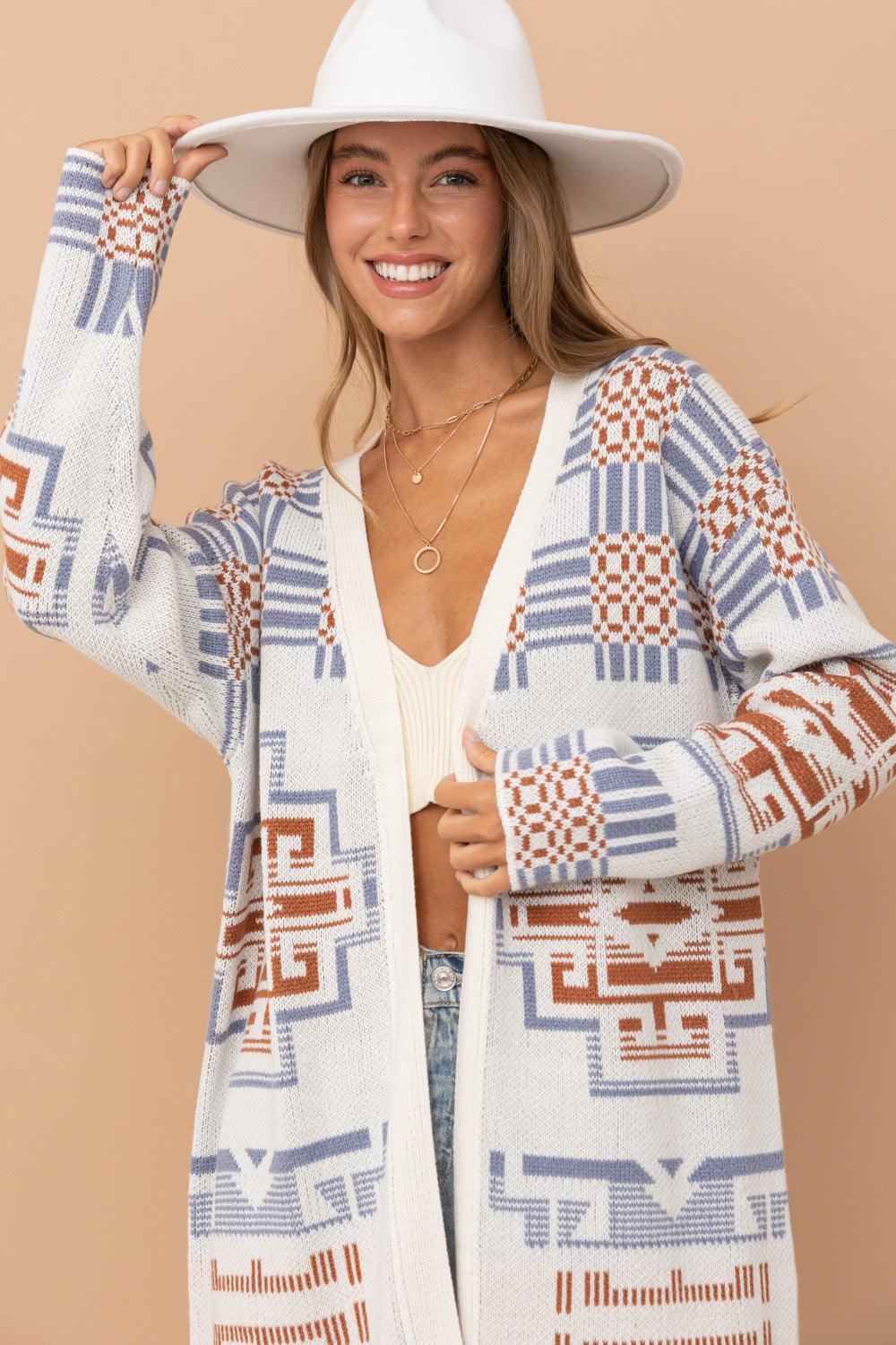 A stylish Erica Aztec Pattern Cardigan draped on a hanger.