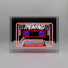 Vibrant Neon 'Cassette' Light in shades of blue, red, green, and pink, encased in a glossy acrylic box with a mirror back, making a striking retro statement.
