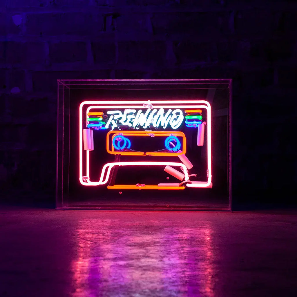Vibrant Neon 'Cassette' Light in shades of blue, red, green, and pink, encased in a glossy acrylic box with a mirror back, making a striking retro statement.