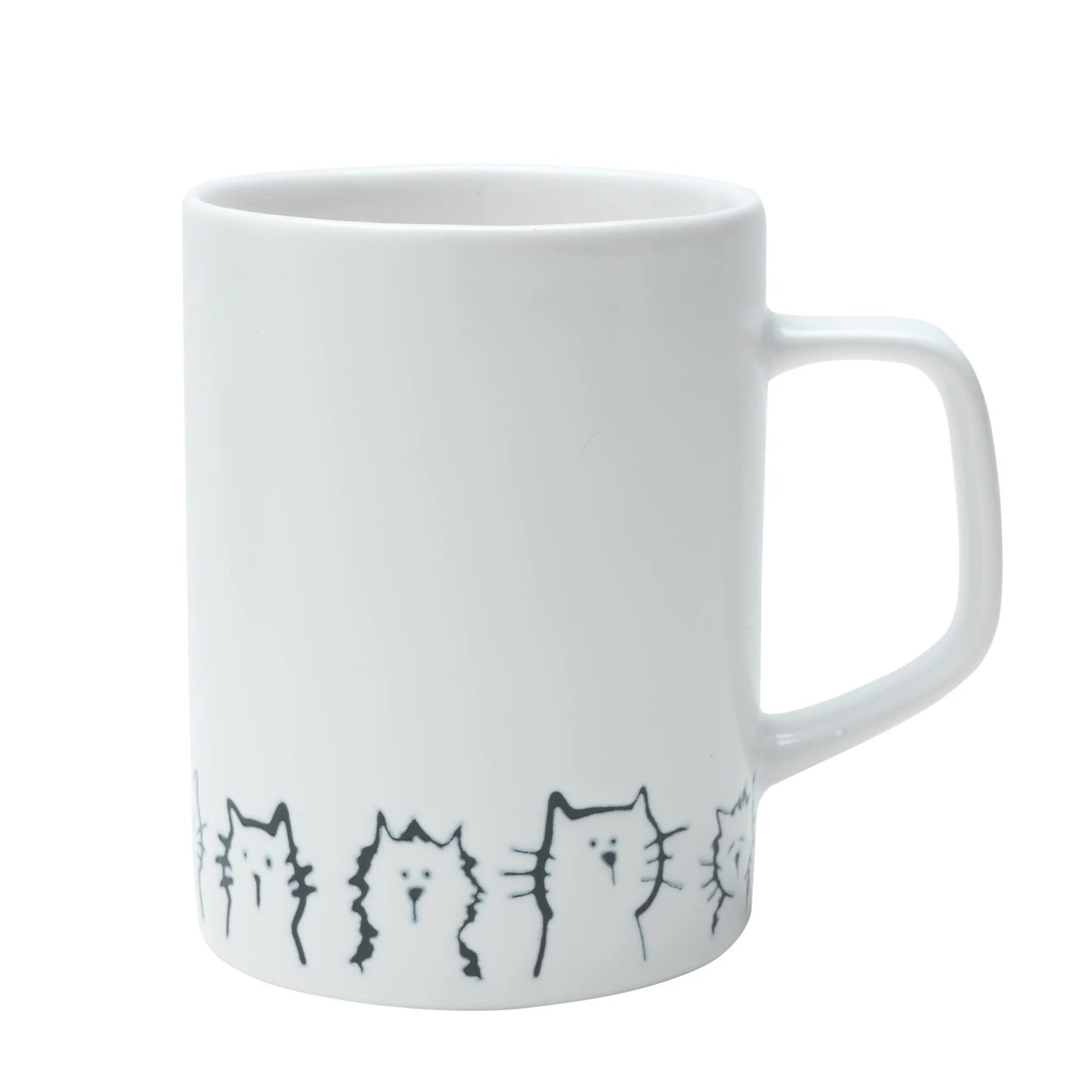 A ceramic mug with a cute cat design, filled with a warm beverage, placed on a table.