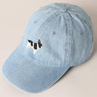 Light-wash denim baseball cap with embroidered black and white French Bulldog design.