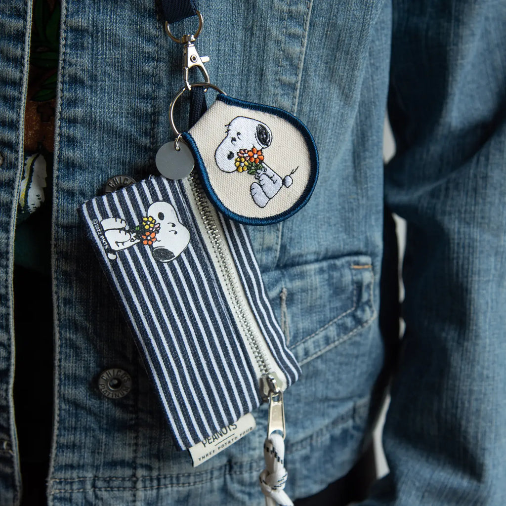 Peanuts Snoopy Flower Bouquet Patch Keychain - A whimsical accessory featuring Snoopy amidst colorful flowers. Perfect for keys or bags.