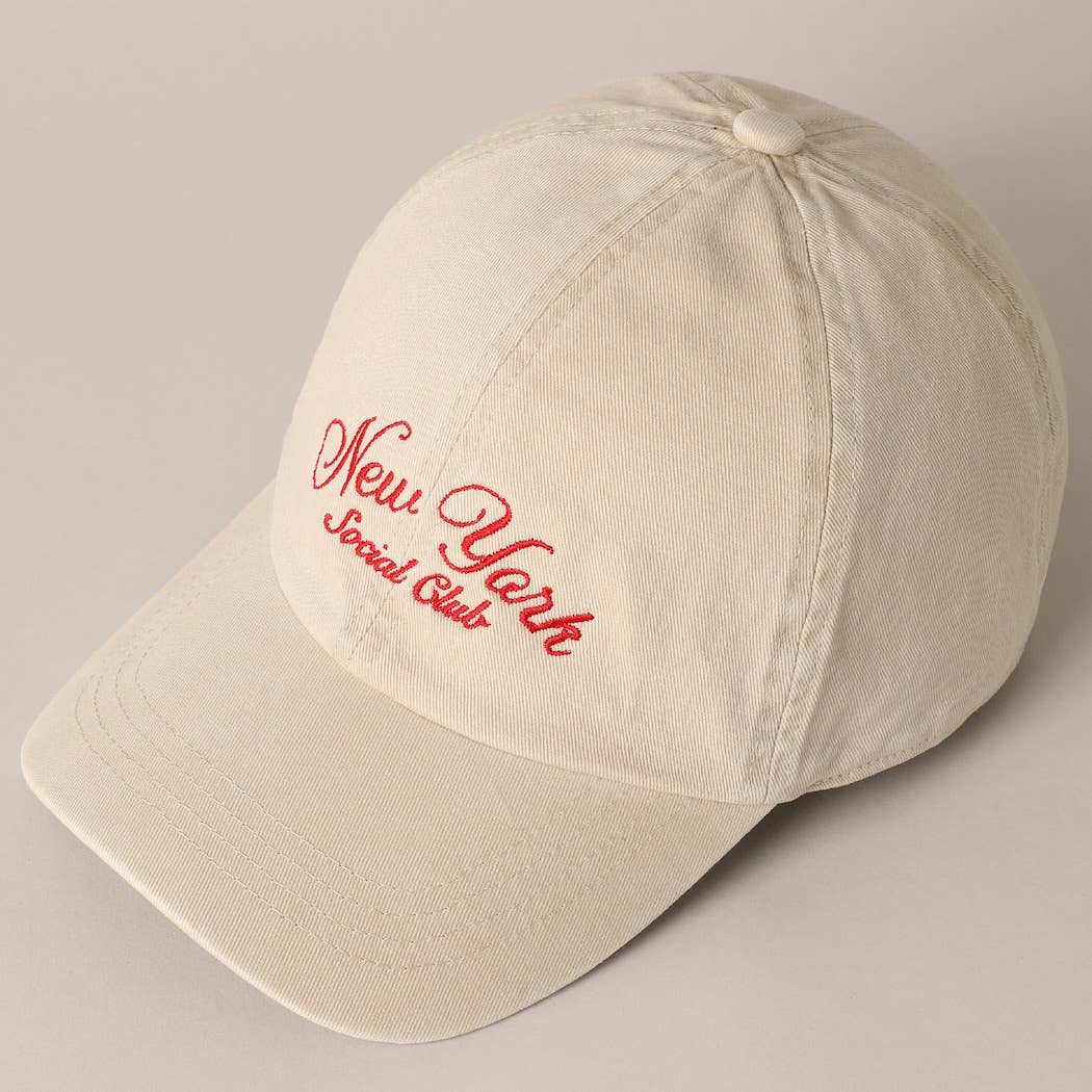 Beige and navy New York Social Club embroidered baseball caps with curved brims.