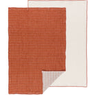 A double weave dishtowel in cinnamon color with a white border, displayed flat.