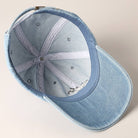 Light-wash denim baseball cap with embroidered black and white French Bulldog design.