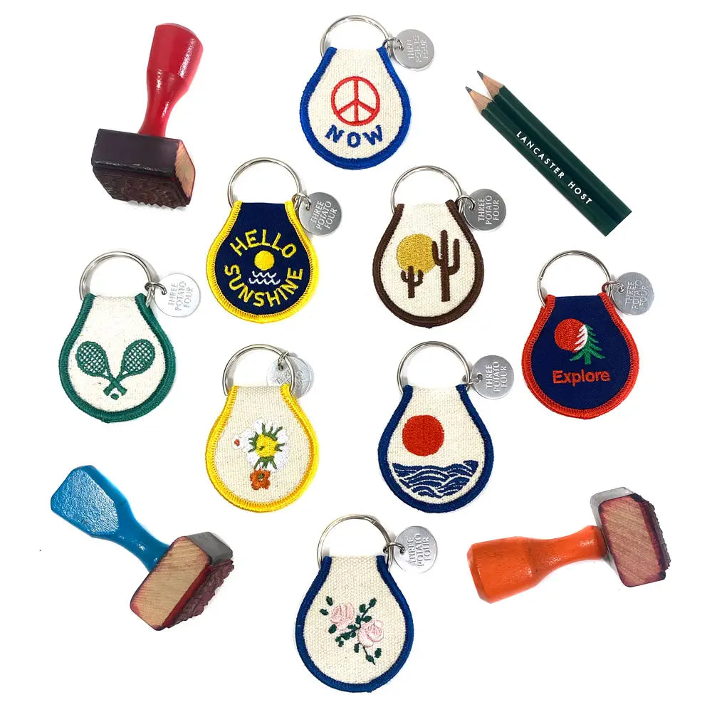 Sun & Waves Patch Keychain - A trendy key accessory with a vibrant sun and waves patch design.