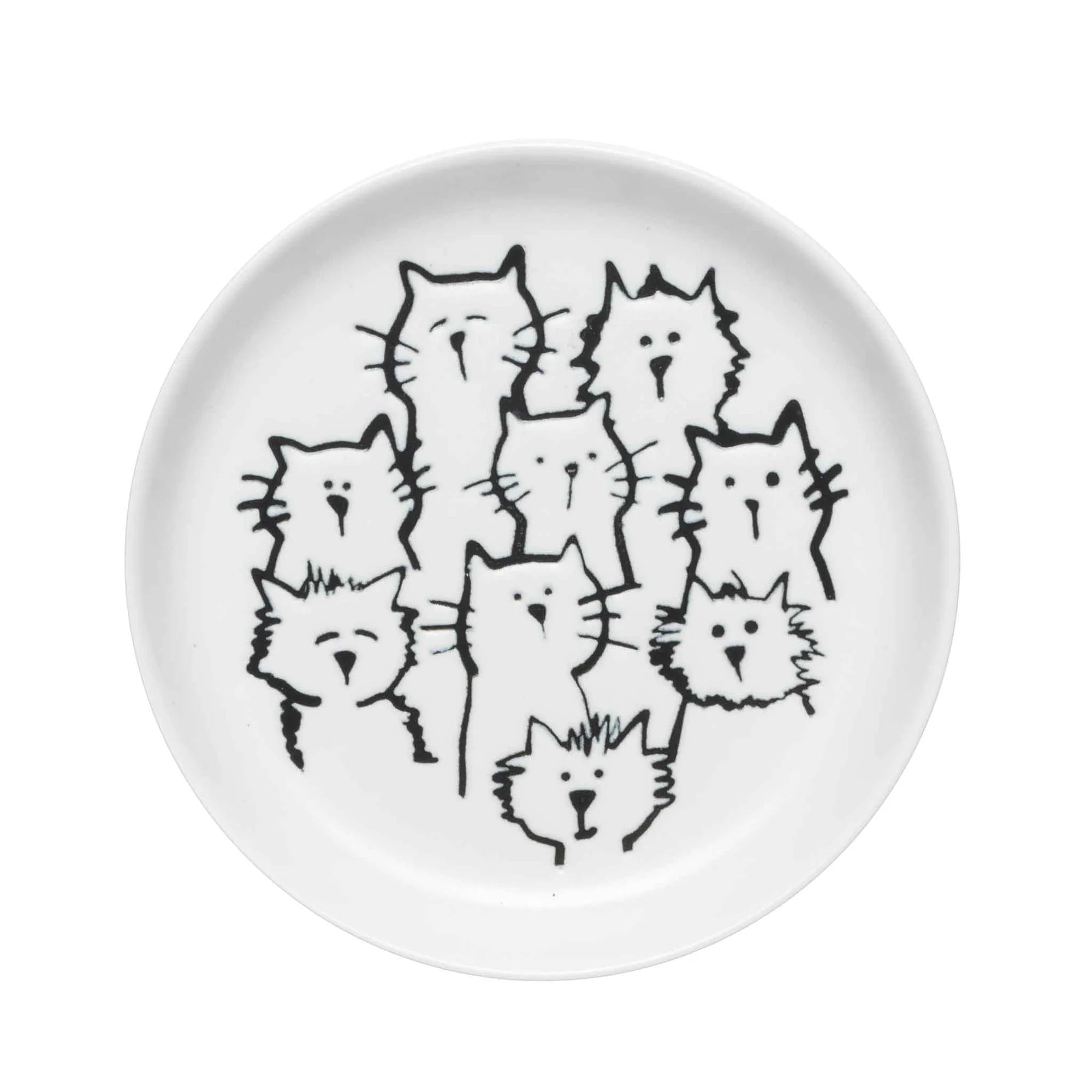 A coaster with an adorable cat-themed design placed on a wooden table.