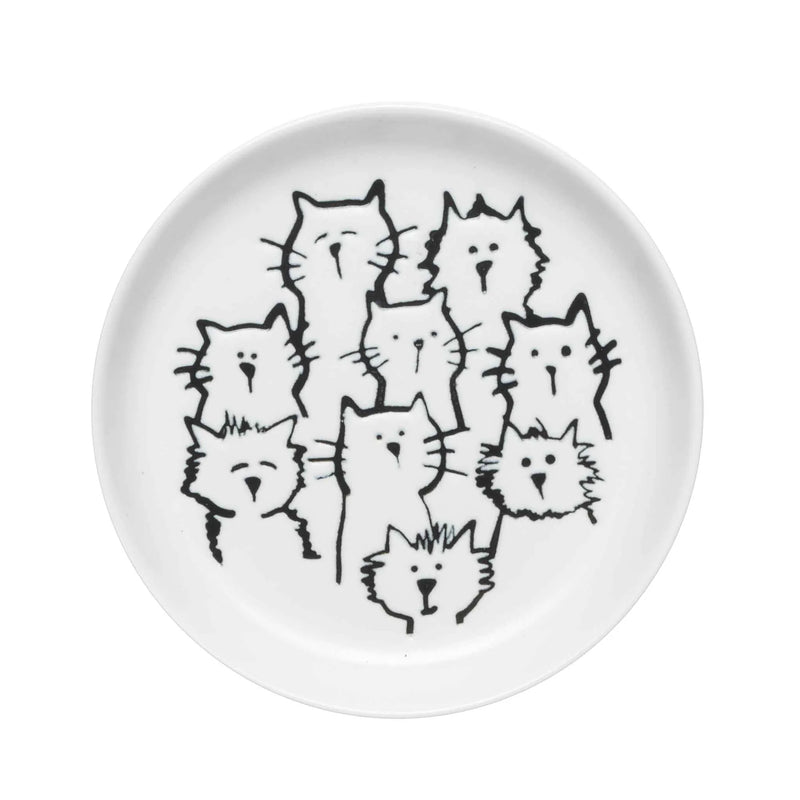A coaster with an adorable cat-themed design placed on a wooden table.