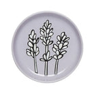 A Lavender Coaster resting on a table, adorned with a vibrant lavender pattern.