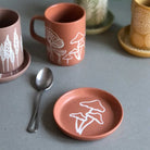 A Mushroom Coaster with a vibrant and fun design, placed on a wooden surface.