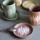 A coaster featuring a beautifully detailed wheat design.