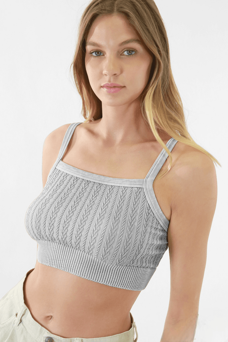 Woman elegantly modeling FORMA's Heather Vintage Chain Knit Bralette, showcasing the intricate chain details and knit pattern.