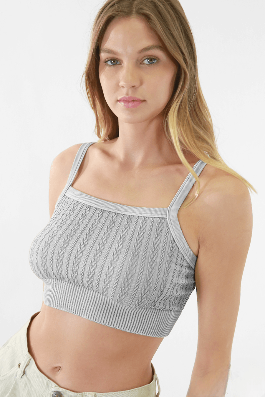 Woman elegantly modeling FORMA's Heather Vintage Chain Knit Bralette, showcasing the intricate chain details and knit pattern.