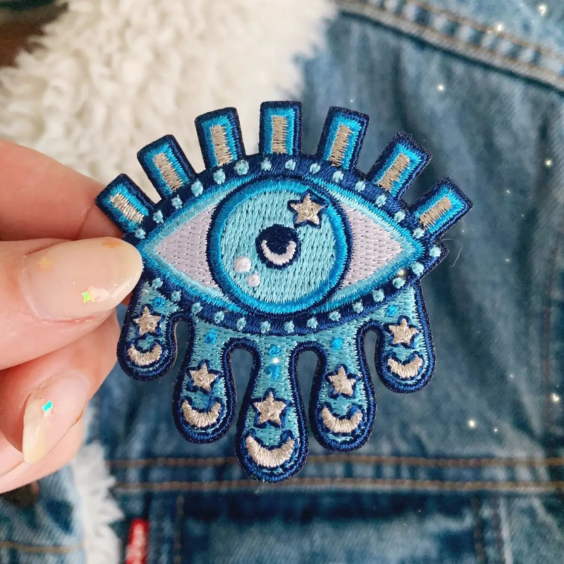 Cosmic Tears Eye Patch, illustrating an eye with tears of cosmic stars and galaxies, symbolizing depth and universe connection.