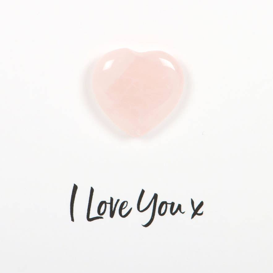 Rose Quartz Greeting Card featuring a small rose quartz heart attached to a card with the text ‘I Love You x’ and a description of rose quartz properties.