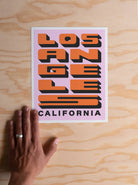 Los Angeles Block Letter Print: A bold print featuring "Los Angeles" in block letters, epitome of urban vibrancy.