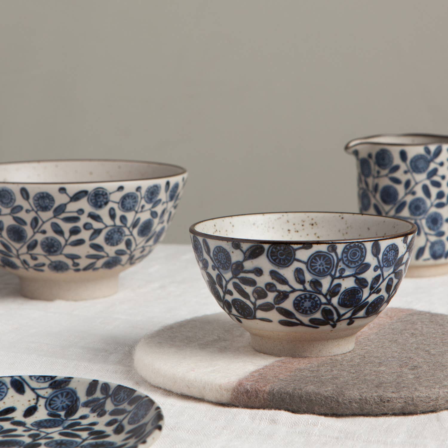 Set of ceramic bowls with blue floral patterns on a neutral background