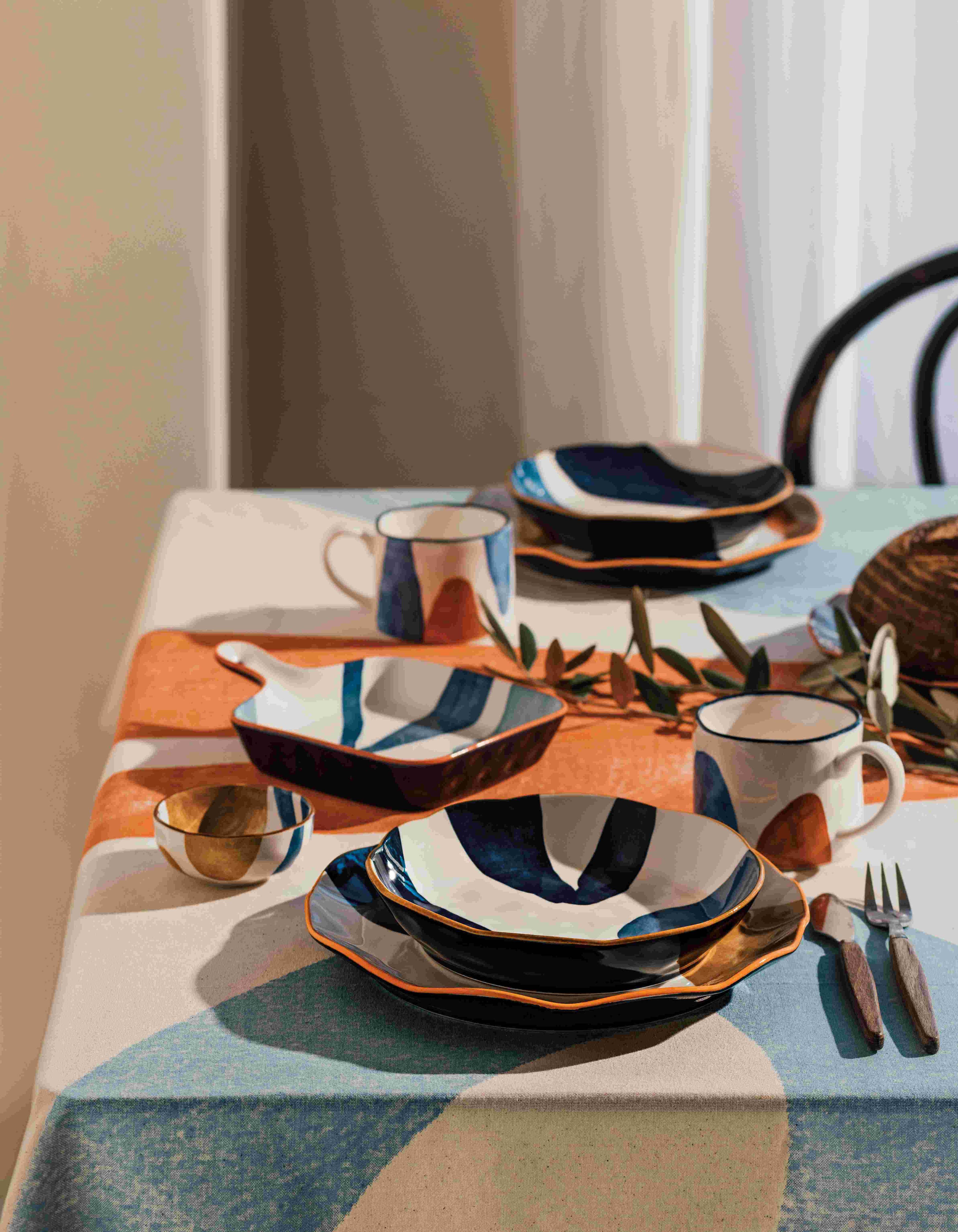 Canvas Stamped Plate with abstract mustard yellow, navy blue, and light blue patterns.