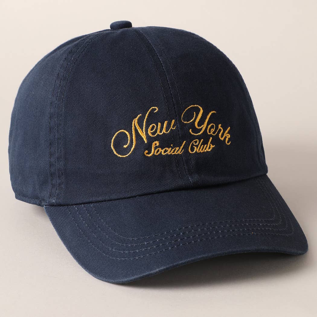 Beige and navy New York Social Club embroidered baseball caps with curved brims.