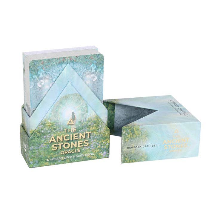 The Ancient Stones Oracle deck featuring serene green-blue packaging with glowing light, floral meadow, and sacred stone illustration.