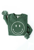 Smiley Face Sweater: Yellow sweater with a large smiley face design.