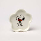 Flower-shaped ceramic trinket dish featuring a black-and-white beagle holding a bouquet of red and orange flowers, packaged in a pink and green gift box.
