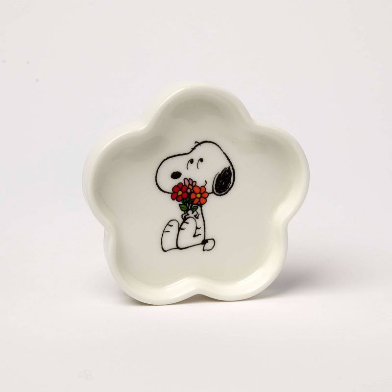 Flower-shaped ceramic trinket dish featuring a black-and-white beagle holding a bouquet of red and orange flowers, packaged in a pink and green gift box.