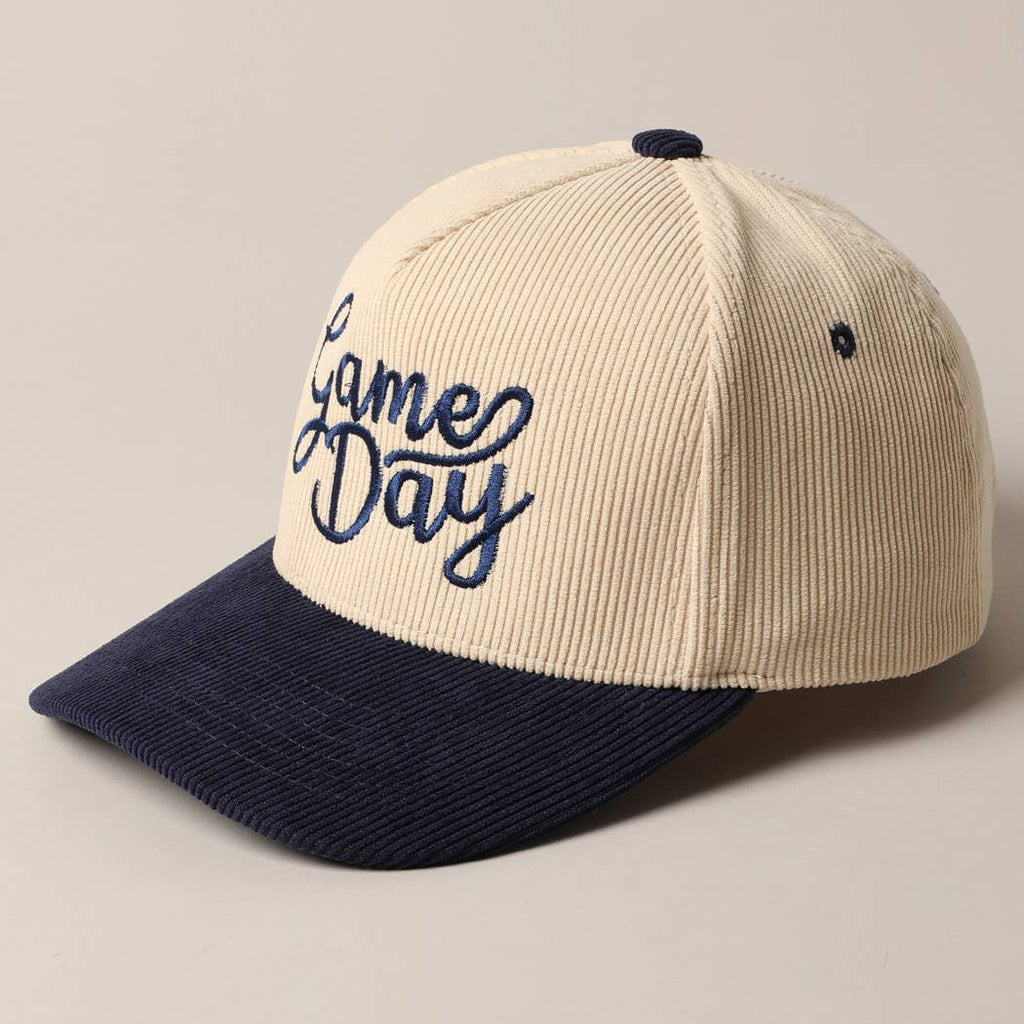 Corduroy trucker baseball cap with "Game Day" embroidered in navy on cream and navy fabric.