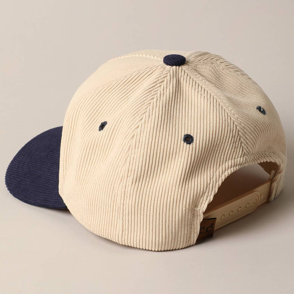 Corduroy trucker baseball cap with "Game Day" embroidered in navy on cream and navy fabric.