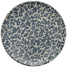 Round ceramic plate with blue leaf pattern on a white background