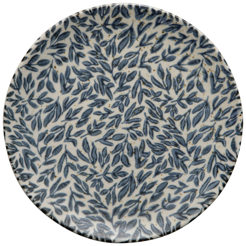Round ceramic plate with blue leaf pattern on a white background