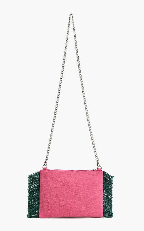 Pink beaded clutch with toucan, butterfly, and tropical floral embroidery, green fringe sides, and silver chain strap.