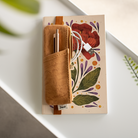 Brown vegan leather notebook pouch with a minimalist design.