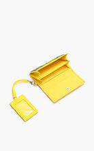 Yellow beaded wallet and card holder set with embroidered sunflower design and green leaf details.